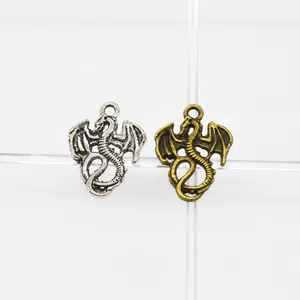 Detail view of dragon charms in antique silver and bronze finishes, sized 21x16x2mm