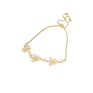 Elegant gold adjustable bracelet featuring three exquisite flower charms with crystals