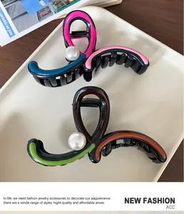 Macro shot of colorful irregular bow hair claw clips with elegant pearl embellishments
