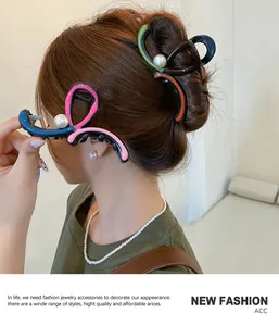 Detail of colorful resin hair claw clip with faux pearls on model's stylish hair