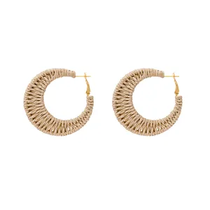 Bohemian style woven rattan hoop earrings with light khaki raffia fiber and gold studs