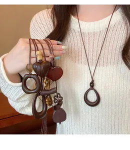 Detail view of ethnic vintage wooden geometric necklaces with brown woven cords