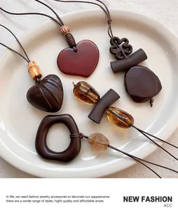 Macro view of vintage resin pendants in heart and flower shapes with warm amber tones