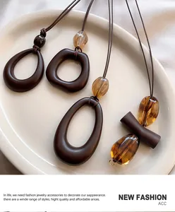 Macro shot of geometric necklaces with resin pendants on a ceramic plate