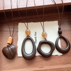 Set of four neo-Chinese hollow geometric pendant necklaces in dark brown matte finish