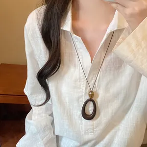 New Chinese hollow geometric pendant necklace with wood ring and amber bead detail