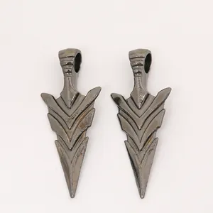Detail of vintage gunmetal alloy arrow pendants with a multi-layered design for jewelry making