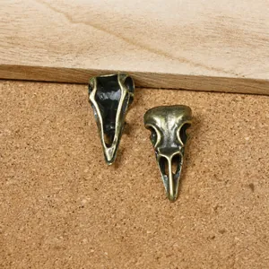 Detail of retro bronze bird skull alloy pendants for DIY gothic jewelry making