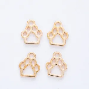 Macro detail of four gold bear paw pendants with hollow design and smooth metal finish