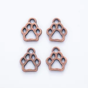 Vintage red copper zinc alloy bear paw pendants in a set of four on white background