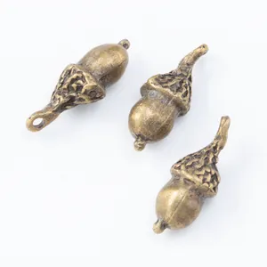 Three vintage bronze acorn charms with realistic scale texture for DIY jewelry making