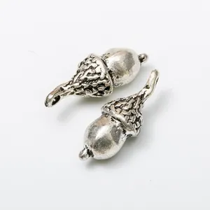 Pair of vintage silver metal acorn pendants with realistic texture for DIY jewelry making
