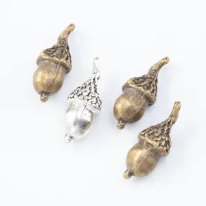 Set of four vintage alloy acorn charms in bronze and silver finishes for DIY jewelry making