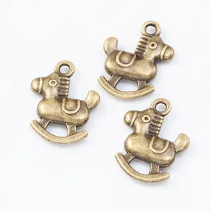 Three vintage bronze rocking horse pendants for DIY jewelry making on white background