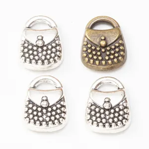 Macro shot of vintage alloy handbag charms with beaded texture for DIY jewelry making