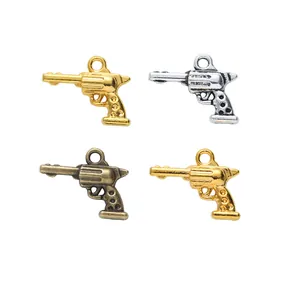 Colgantes de revólver vintage en aleación de zinc, acabados oro, plata y bronce para DIY