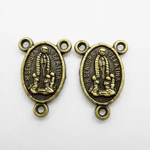 Detailed close-up of vintage bronze Our Lady of Fatima rosary center connectors