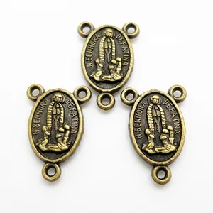 Macro detail of bronze religious connectors featuring Virgin Mary relief and three-hole design