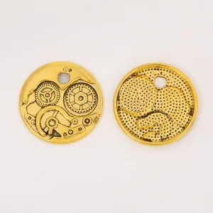 Detail of vintage steampunk gear pendants in gold finish for DIY jewelry crafts