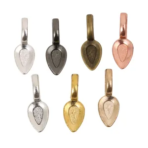 Set of seven vintage alloy shovel pendants in various metallic finishes for DIY jewelry making