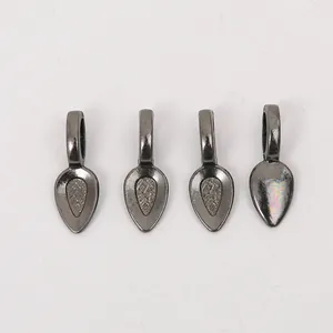 Macro detail of gunmetal teardrop pendants with textured center for DIY jewelry making