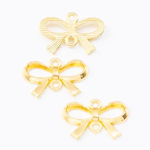 Golden zinc alloy bow charm with double loops for DIY jewelry making and craft projects