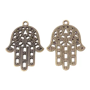 Vintage bronze Hamsa Hand alloy charm showing detailed hollow floral patterns and textured back