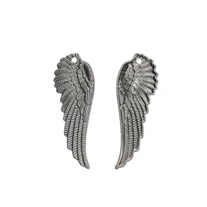 Macro view of detailed feather texture on antique silver wing pendants for DIY jewelry