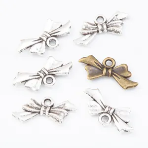Set of six vintage alloy bow pendants in antique silver and bronze for DIY jewelry making