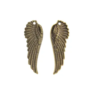 Pair of vintage bronze wing pendants with detailed feather texture for DIY jewelry making