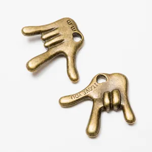Detail of vintage bronze alloy hand charms with I LOVE YOU engraving for DIY jewelry
