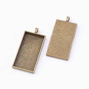 Macro detail of vintage bronze rectangle alloy pendant tray with textured DIY surface