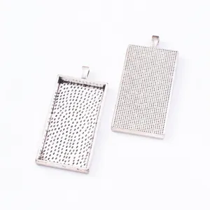 Macro detail of rectangular vintage silver alloy jewelry pendants with grid texture
