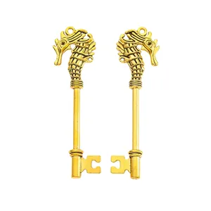 Macro detail of vintage gold seahorse-shaped key pendants with intricate carvings