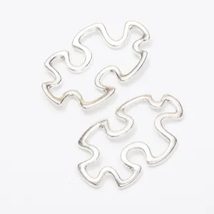 Pair of vintage silver alloy puzzle piece connector pendants with hollow design