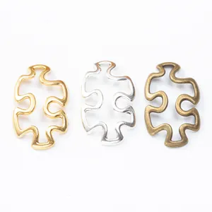 Three puzzle piece metal connectors in gold, silver, and bronze finish for DIY jewelry making