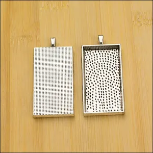Detailed front and back view of silver rectangle alloy pendant trays for DIY jewelry