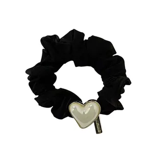Elegant black velvet scrunchie with a pearl heart charm and a small handmade metal tag