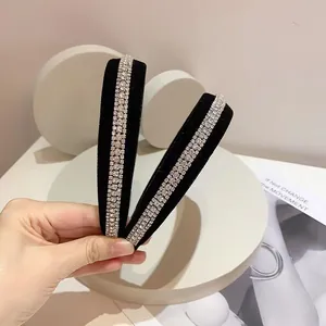 Set of two black velvet headbands featuring three rows of sparkling white rhinestones