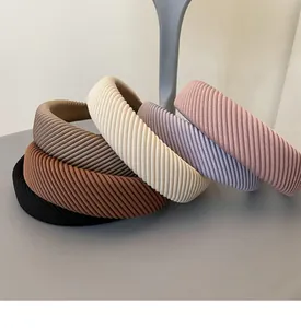 Detail showing various colors of thick sponge headbands with ribbed knit fabric texture