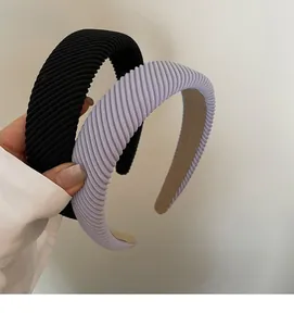 Detailed texture of thick ribbed fabric headbands in black and lilac for hair styling