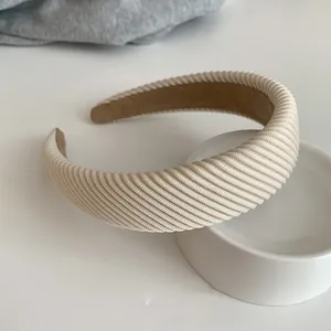 Detail of cream rib-knit sponge headband with brown non-slip velvet inner lining