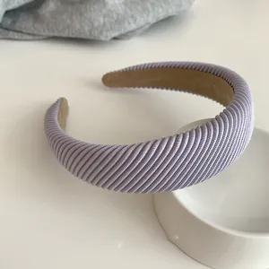 Detail showing the lavender padded headband with diagonal texture on white ceramic décor
