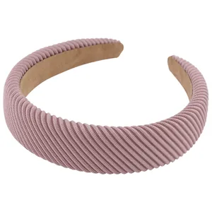 Chic pink padded headband with diagonal striped texture for high cranial top style