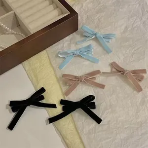 Elegant velvet bow hair clips set in light blue, pink and black for women styling