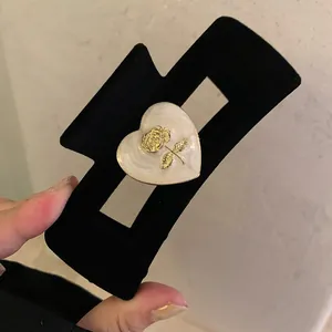 Large black velvet hair claw clip with vintage white heart and golden rose detail
