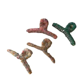 Set of four colorful knit wool hair claws in various mosaic autumn winter patterns