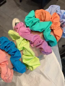 Close-up of colorful pleated fabric scrunchies in vibrant pastel and neon shades
