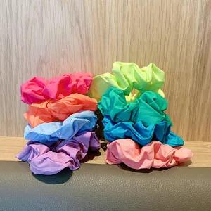 Close-up of 8-pack colorful fabric scrunchies showing pleated texture and vibrant tones