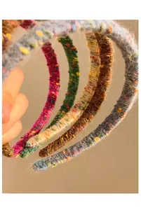 Detail of colorful plush knit headbands showing fuzzy wool texture and thick braided design